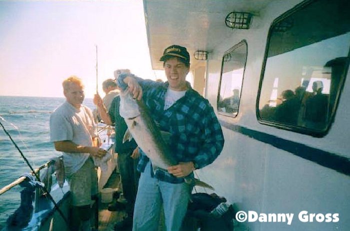 My cousin Danny on a day fishing trip and catching a nice amberjack.