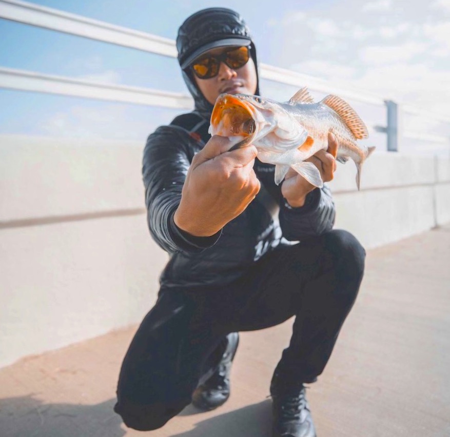 Open mouth speckled sea trout caught on a fishing pier.