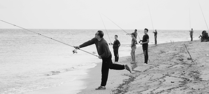 Beach fishing - using a long surf-rod to reach further out into the water and get to deeper water and more fish.