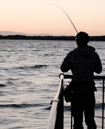 Fishing from a pier at sunset in Ft. Myers, Florida.
