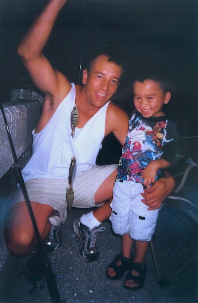 Child fishing with father off Sunshine Skyway Fishing Pier in St. Petersburg, Florida.
