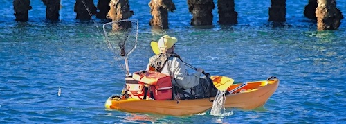 Man fishing from Kayak inshore on the Florida Coast.