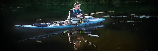 Kayak fishing on flat ocean water.