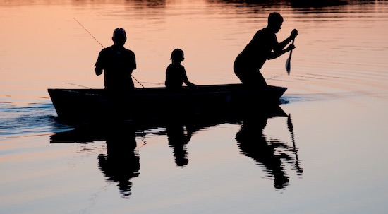 Family fishing on a boat in Florida.