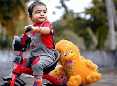 Small boy - fish fry - refuses to go to fishing pier without his bike and bird.